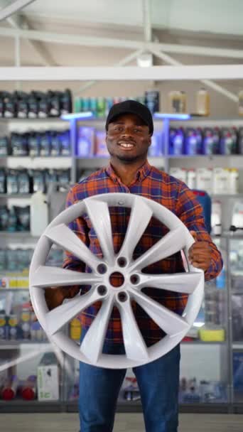 Μαύρος Πωλητής Δίνει Δίσκο Τροχού Αυτοκινήτου Στον Αγοραστή — Αρχείο Βίντεο