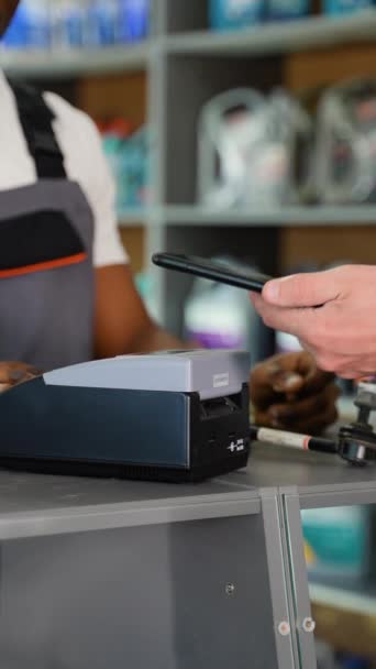 Man Buys Auto Parts Paying Contactless Nfc Smartphone Touching Terminal — Stok Video