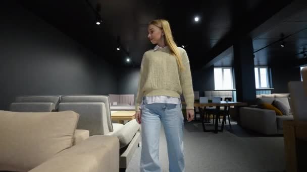 Young Woman Chooses New Sofa Luxury Furniture Shop — Stock Video