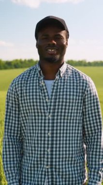 Afrika kökenli Amerikalı bir çiftçinin buğday tarlasındaki portresi. Akıllı tarım konsepti. Tarım, iş ve kırsal konsept