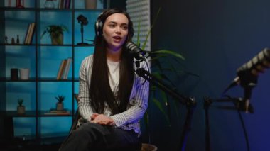 Radyo podcast oturumu sırasında canlı yayın yapan iki blog yazarı, seyircilerini dinamik ve etkileşimli bir tartışmaya dahil etmek için profesyonel ekipmanlar kullanıyorlar.