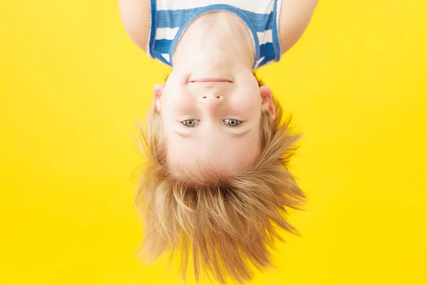 Happy Child Smiling Yellow Paper Background Funny Kid Hanging Upside — Stock Photo, Image