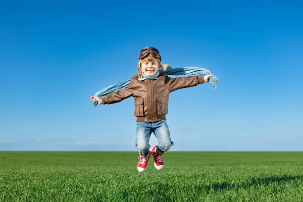 春の緑のフィールドで屋外ジャンプ幸せな子供 青い空を背景に楽しい子供 想像力と自由の概念 — ストック写真