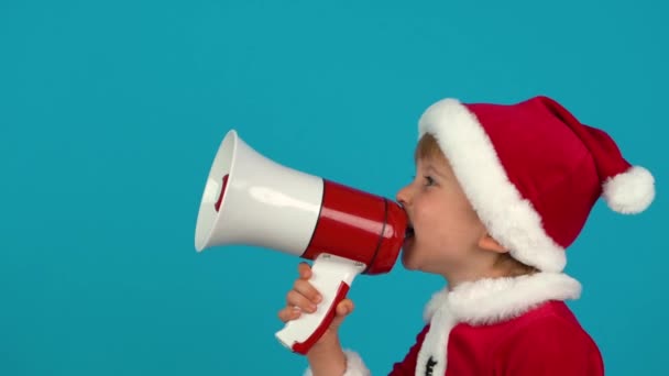 Child Wearing Santa Claus Hat Shouting Loudspeaker Blue Background Christmas — Video Stock