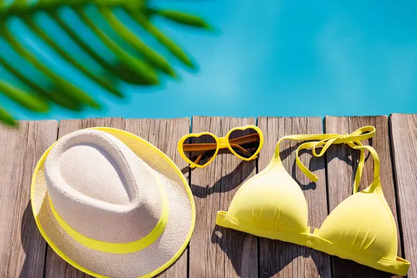 Strandbadeanzug Und Sonnenbrille Auf Holzgrund Dinge Für Den Urlaub Gegen lizenzfreie Stockfotos