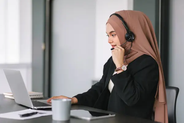 Asian muslim operator woman agent with headsets working in a call centre