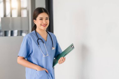 Portrait of healthcare professional holding medical lab patient health check form at hospital