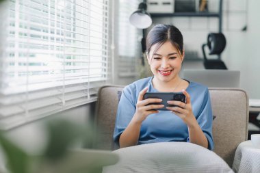 Smiling Woman Enjoying Social Media on Smartphone