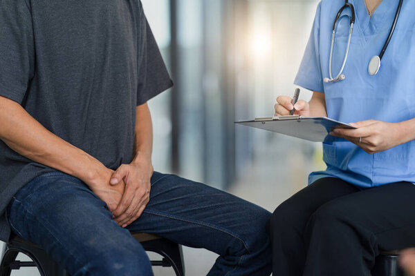 Male doctor and testicular cancer patient are discussing about testicular cancer test report. Testicular cancer and prostate cancer concept