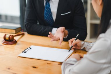 Takım elbiseli adamla profesyonel toplantı ve belge imzalayan kadın.