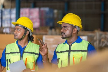 Workers team taking inventory in factory warehouse, Foreman workers working in warehouse talking about job