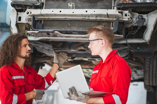Young Mechanics Team Uniform Working Auto Service Lifted Vehicles Car — Stock Photo, Image