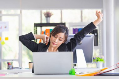 Ofis sendromu, Asyalı bir kadının iş zamanı kollarını esnetmesi, kadın memurun yorgun ve yorgun hissetmesi ve dinlenmek için esnemesi.