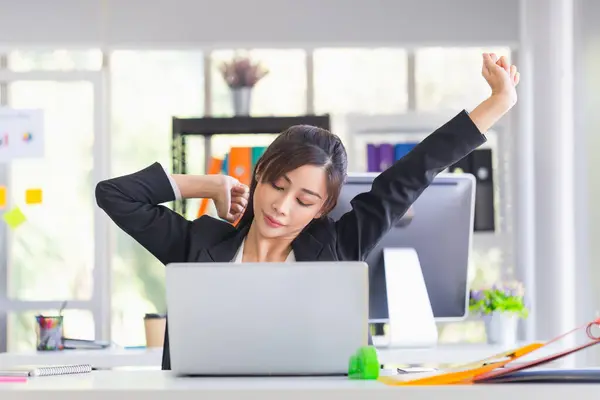 Office syndrome, Asian woman doing stretch exercise stretching her arms in work time, Female officer feeling tired and fatigue stretching to relax