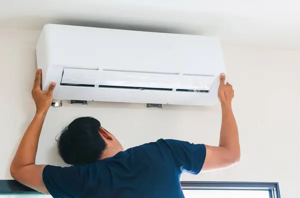 Air conditioning technicians prepare to install new air conditioners in home, Air conditioner repair and installation concept