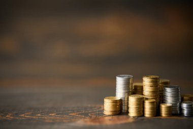 Tahta arka planda metin için fotokopi alanı olan bozuk paralar. Finans, bankacılık ve yatırım kavramı.