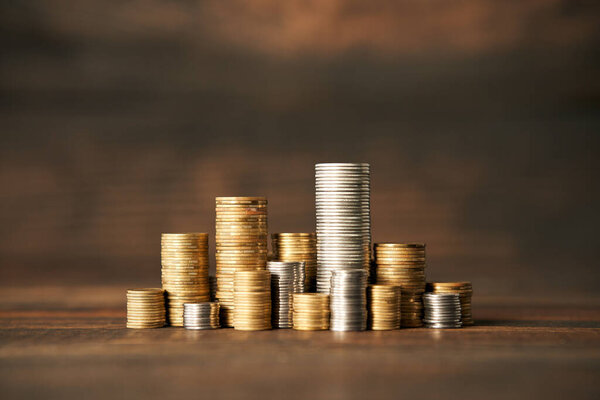 Coins stacks on wooden background. Finance, money, banking and investment concept.