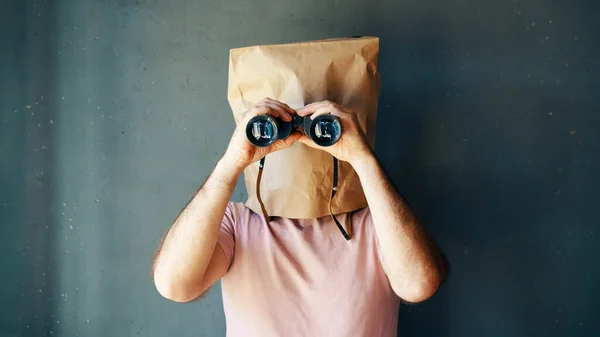 Homem Com Saco Papel Cabeça Olhando Através Binóculos Para Câmera — Fotografia de Stock