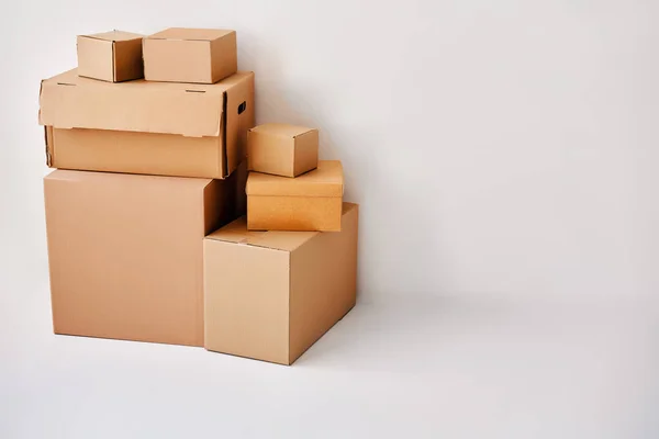 stock image Moving and relocation concept. Heap of cardboard boxes on white backround with copy space