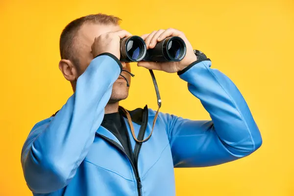 Young Man Looking Binoculars Isolated Yellow Background Side View — Stock Photo, Image