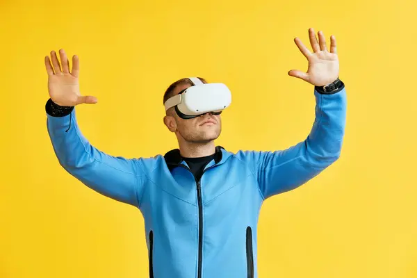 在黄色背景上戴着虚拟现实护目镜的人 未来的概念 图库照片