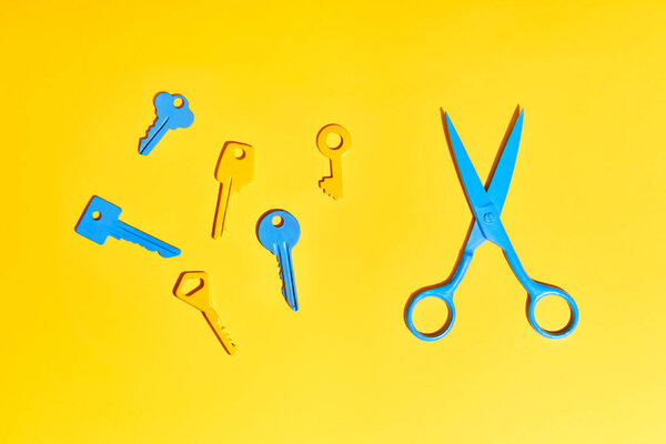 Blue Scissors Colorful Keys Yellow Background Stock Picture