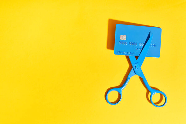 Blue Scissors Cutting Credit Card Yellow Background Copy Space Finance Royalty Free Stock Photos
