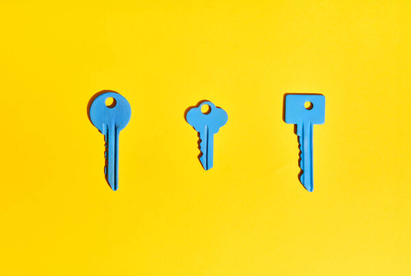 Blue Keys Vibrant Yellow Background Flat Lay Stock Photo