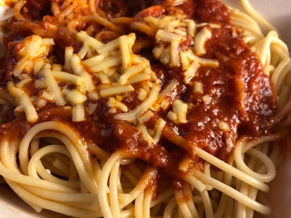 Close-up of a spaghetti with red sauce and cheese