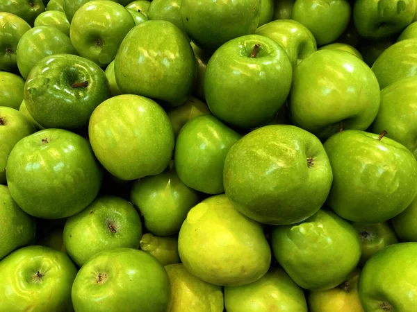 Medium close up shot of a bushel of green apples