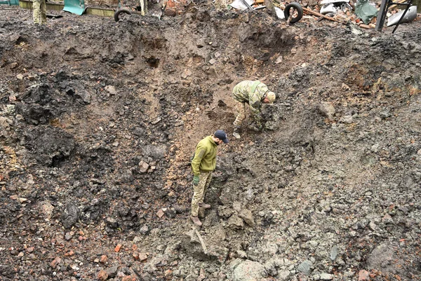 stock image Lviv region, Ukraine - November 16, 2022: Experts examine a crater after a Russian missile strike in a village, near the Ukrainian city of Lviv. 