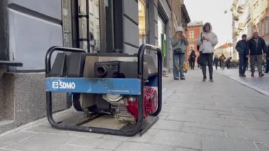 Lviv, Ukrayna - 29 Aralık 2022: Ukrayna enerji altyapısına yapılan Rus hava saldırıları sonrasında, şehir planlanan bir elektrik kesintisinden geçerken, kafenin dışında bir elektrik jeneratörü çalışıyor.