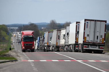 Lviv region, Ukraine - April 18, 2023: A long line of trucks near the Rava-Ruska border checkpoint on the Ukrainian-Polish border. clipart
