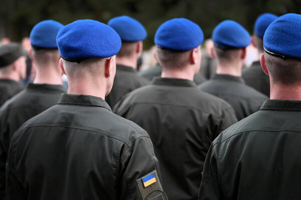 Ukrainian soldiers. Ukrainian army. Ukrainian flag on military uniform. Troops of Ukraine. Soldier from the back