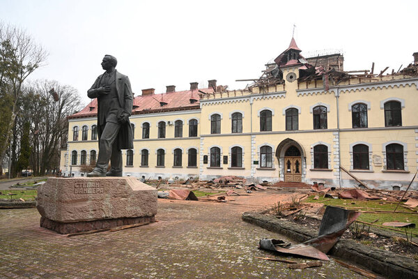 Lviv, Ukraine - January 1, 2024: Monument of Stepan Bandera near the damaged Lviv National University of Nature Management, after a Russian drone attack in Lviv.