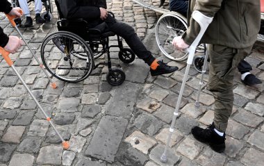 a men with amputated legs in a wheelchair at the cobblestones. inclusiveness clipart