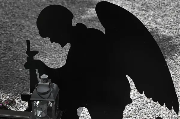 stock image silhouette of a kneeling soldiers. warrior in the form of an angel. memorial day