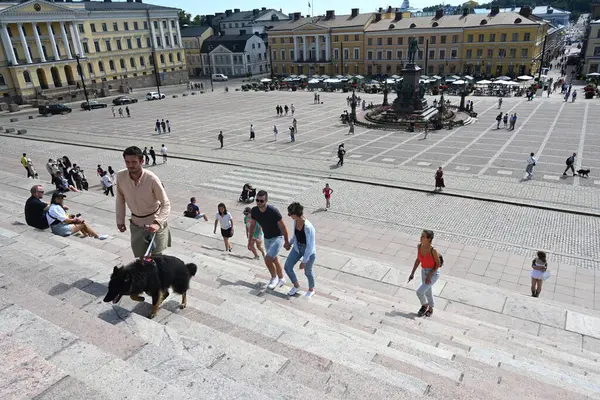 stock image Helsinki, Finland - July 25, 2024: A people on the  Senate Square (Senaatintori) in Helsinki.