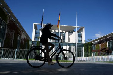 Berlin, Germany - August 3, 2024: People near the Federal Chancellery Complex. The Federal Chancellery (Bundeskanzleramt) in Berlin is the official seat and residence of the chancellor of Germany. clipart