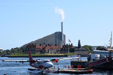 Copenhagen, Denmark - August 1, 2024: Amager Bakke, also known as Amager Slope or Copenhill, is a combined heat and power waste-to-energy plant and recreational facility in Copenhagen, Denmark. clipart