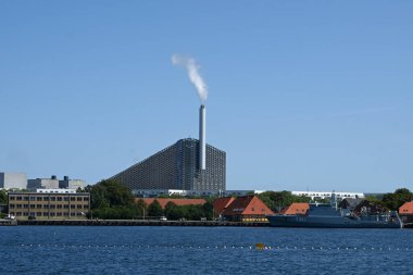 Copenhagen, Denmark - August 1, 2024: Amager Bakke, also known as Amager Slope or Copenhill, is a combined heat and power waste-to-energy plant and recreational facility in Copenhagen, Denmark. clipart