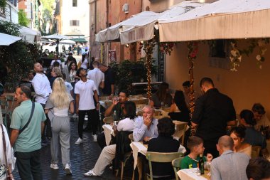 Roma, İtalya - 31 Ekim 2024: Roma 'nın Trastevere ilçesindeki bir kafede insanlar dinleniyor.