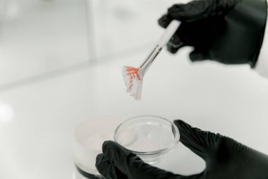 Kozmetik uzmanı kozmetik tozu ve fırça kullanarak beyaz bir yüz maskesi hazırlıyor..