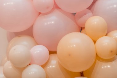 Pembe ve mercan ya da farklı boyutlarda bej balonlar. Dekoratif duvar. Ses düzeyi dekorasyonu.