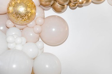 White and gold balloons with confetti on a white background are creating an elegant and festive atmosphere. Background. Festive background. clipart