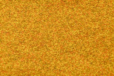  Çiğ sarı arı polen taneciklerinin dokusu doğal bir organik desen oluşturuyor. Sağlıklı yemek ve ek temalar için arka plan olarak kullanılabilir.