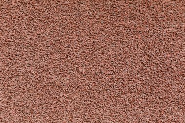 Küçük koyu kahverengi çakıl taşlarının detaylı bir yakın çekim dokusu. Eşit olarak yayılmış, engebeli ve topraksı bir his yaratıyor. Arkaplan ve inşaat temaları için ideal..