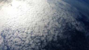 Cloudy Day With Blue Sky And Sun Showing Trough Clouds
