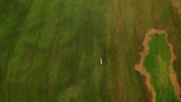 Aerial View Golf Course Man Hits Ball Walks Field Green — Stock Video