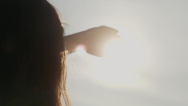 Female Hand Background Sky Sun Rays Illuminate Hand — Stock Video